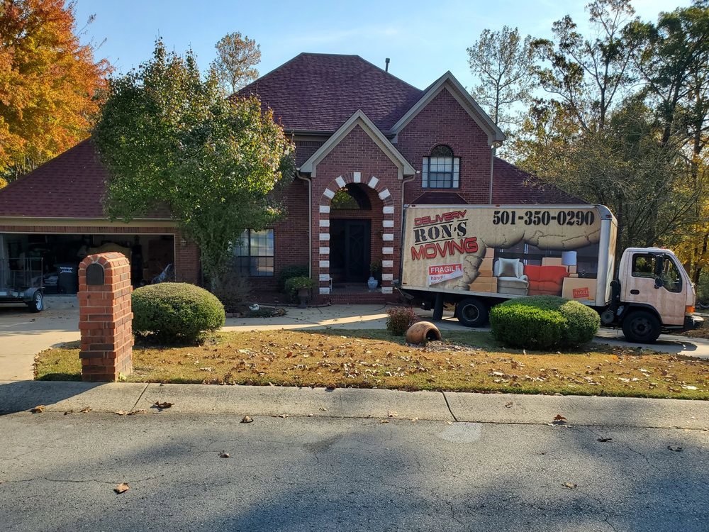 Ron's Moving truck parked in front of a residential home, ready for a move in Little Rock, AR.