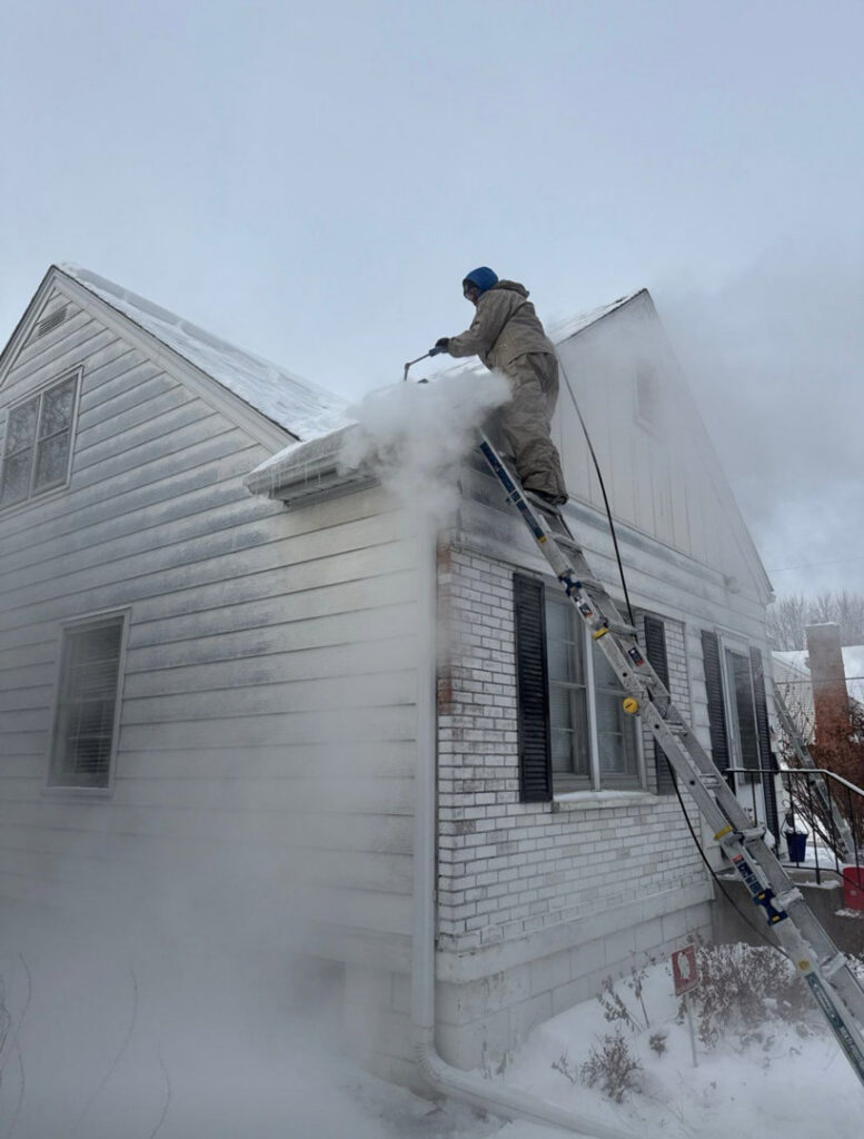 Keystone Home Services performing professional ice dam steaming on a residential roof in Middletown, DE to mitigate water damage.