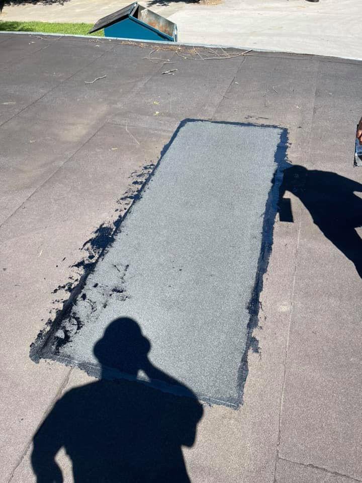 A section of a commercial roof showing a fresh patch repair, indicating work to prevent or fix water leaks by UpKeep Properties, LLC in Elizabethtown, KY.