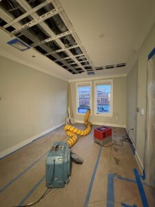 A room with a removed ceiling and drying equipment for water damage restoration by Mold Master Restoration in Jersey City, NJ