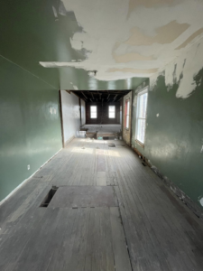 A gutted room with exposed floorboards and ceiling joists, a project by Identical Demolition LLC in Philadelphia, PA.