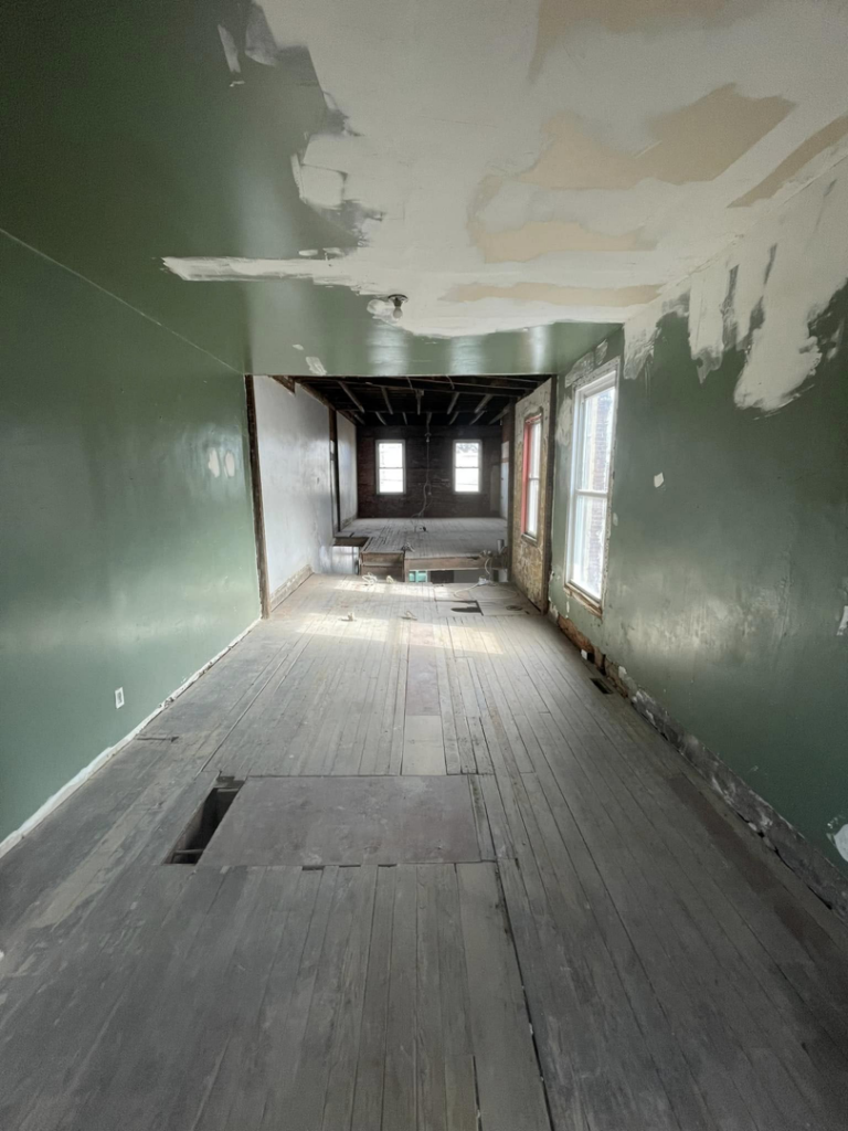 A gutted room with exposed floorboards and ceiling joists, a project by Identical Demolition LLC in Philadelphia, PA.