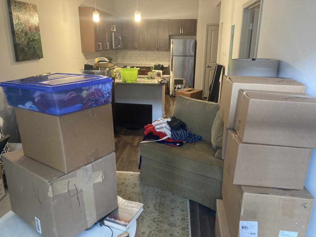 A room filled with packed boxes and furniture, indicating a move in progress by Rambling Man Logistics in Hildebran, NC.