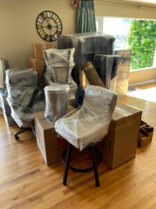 A room with furniture and boxes packed and shrink-wrapped, ready for moving by Packman Moving in San Diego, CA