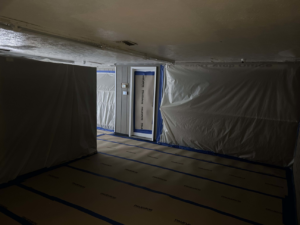Room with plastic containment set up for water damage mitigation by Paul Davis of Eastern Ohio in Youngstown, OH.