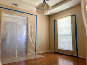 Room with plastic containment and a drying fan for water damage remediation by 1st Response Emergency Repairs, LLC in Scott, LA.