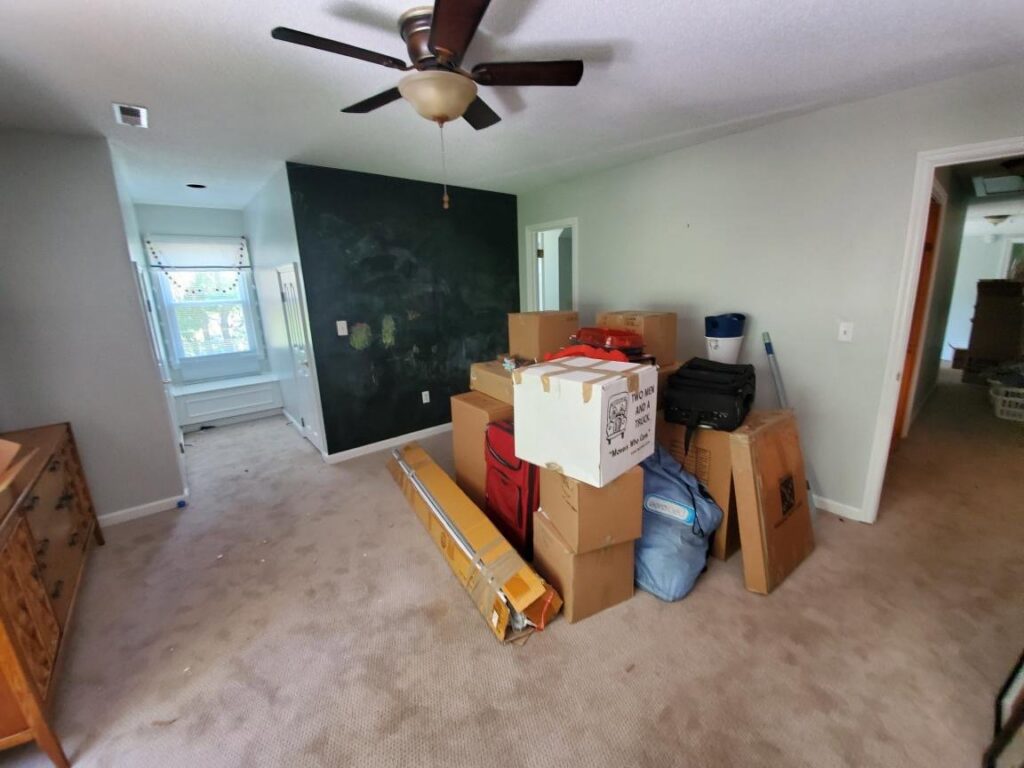 A room filled with moving boxes and packed items, indicating a residential move handled by Miracle Movers of Charleston, SC in Summerville, SC.