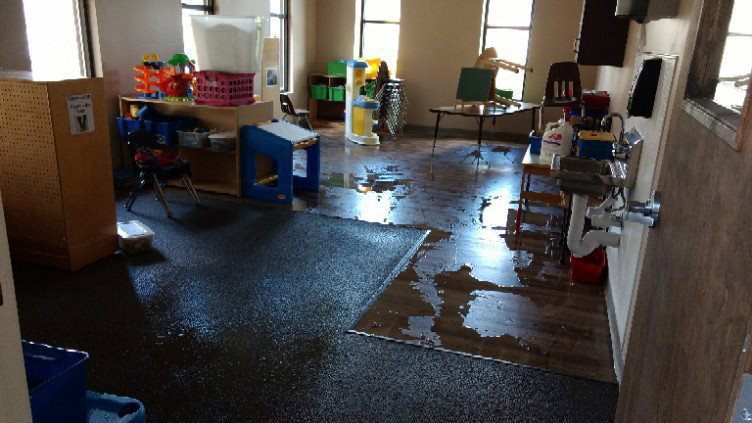 A room with standing water on the floor, indicating significant water damage, handled by Water Damage Pro in Minneapolis, MN