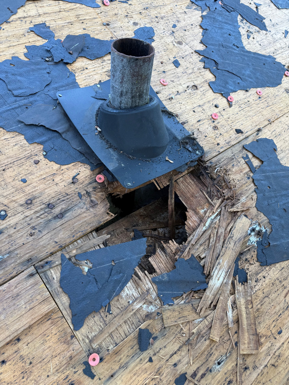 Severe water damage with rotted roof decking and a hole around a vent pipe, repaired by Valor Restoration in Richmond, KY