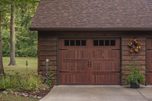 A rustic garage with a dark wooden garage door and decorative hardware from Jim Dyer Overhead Door in Carson City, NV