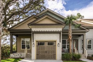 A charming house featuring a rustic-style wooden garage door installed by Overhead Door Company of Little Rock in North Little Rock, AR.