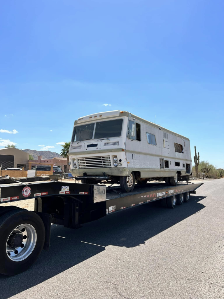 A large RV being transported on a flatbed trailer by P&A towing & transport Llc in Phoenix, AZ