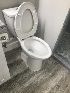 A sanitized and sparkling clean toilet in a modern bathroom, demonstrating A Clean Xscape LLC's house cleaning in Chandler, AZ.