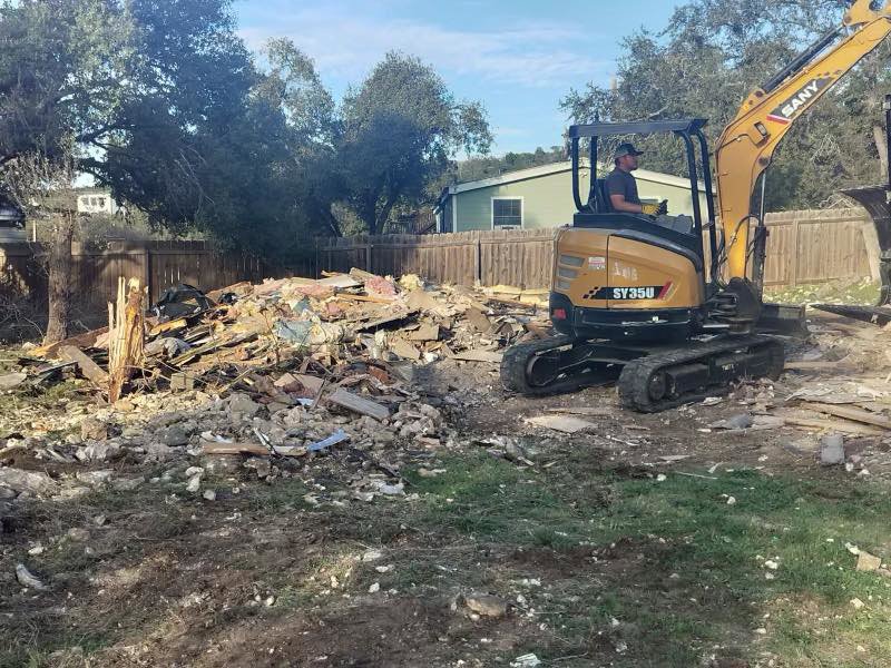 A SANY excavator next to a large pile of demolition debris after a job by San Antonio Demolition Pros in San Antonio, TX.