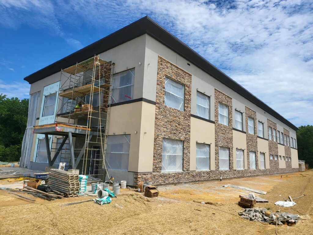 Scaffolding set up for stucco and stone siding installation on a commercial building by Eastern Stucco Restorations in Rock Hill, SC.
