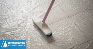 A person scrubbing a tiled floor with suds at a home cleaned by Intermountain Cleaning Service in Yakima, WA