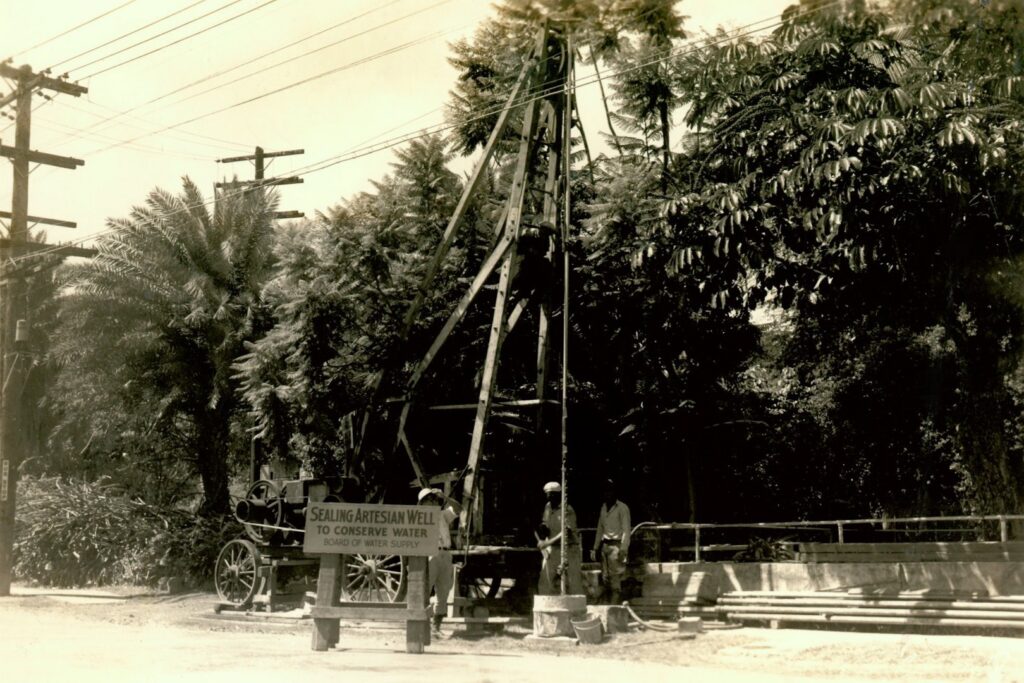 Workers operating a drilling rig to seal an artesian well for water conservation by Honolulu Board of Water Supply in Honolulu, HI.