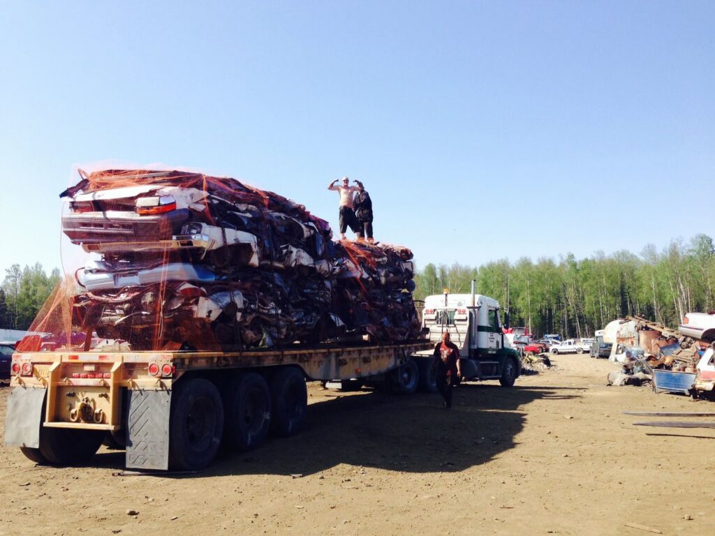 A semi-truck transporting a load of crushed cars for AK Car Crushing & Recycling & ACCR Towing in Wasilla, AK.