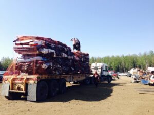 A semi-truck transporting a load of crushed cars for AK Car Crushing & Recycling & ACCR Towing in Wasilla, AK.