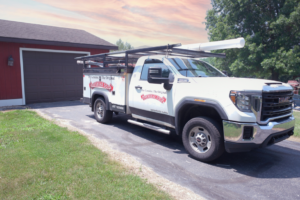 A branded service truck from Overhead Door Company of Casper, Inc & Architectural Glazing Contractors parked at a job site in Casper, WY.