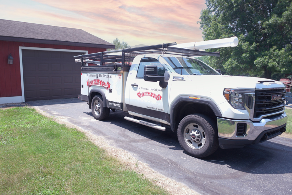 A branded service truck from Overhead Door Company of Casper, Inc & Architectural Glazing Contractors parked at a job site in Casper, WY.