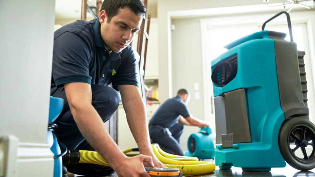 ServiceMaster technicians setting up water drying and restoration equipment in a home in Aberdeen, SD.