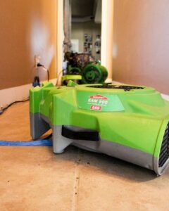 A SERVPRO EAM 900 Low Profile Air Mover drying a tiled floor after water damage in Alexandria, LA.