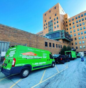 SERVPRO of Brandywine/Wilmington Disaster Recovery Team vehicles parked outside a large commercial building in Wilmington, DE.