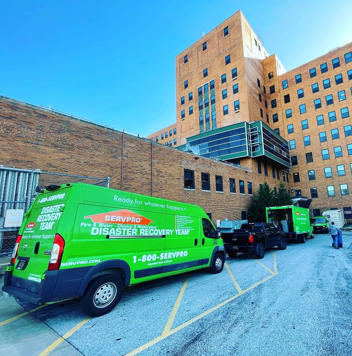 SERVPRO of Brandywine/Wilmington Disaster Recovery Team vehicles parked outside a large commercial building in Wilmington, DE.