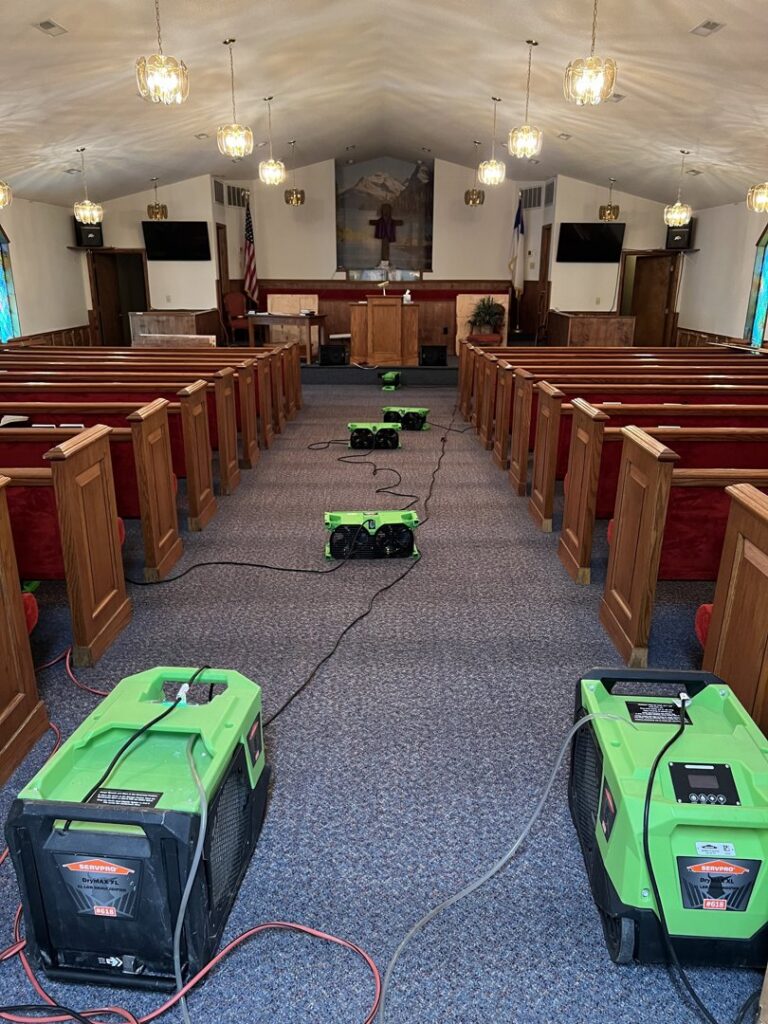 Servpro drying equipment deployed in a church sanctuary for water damage restoration in Athens, AL.