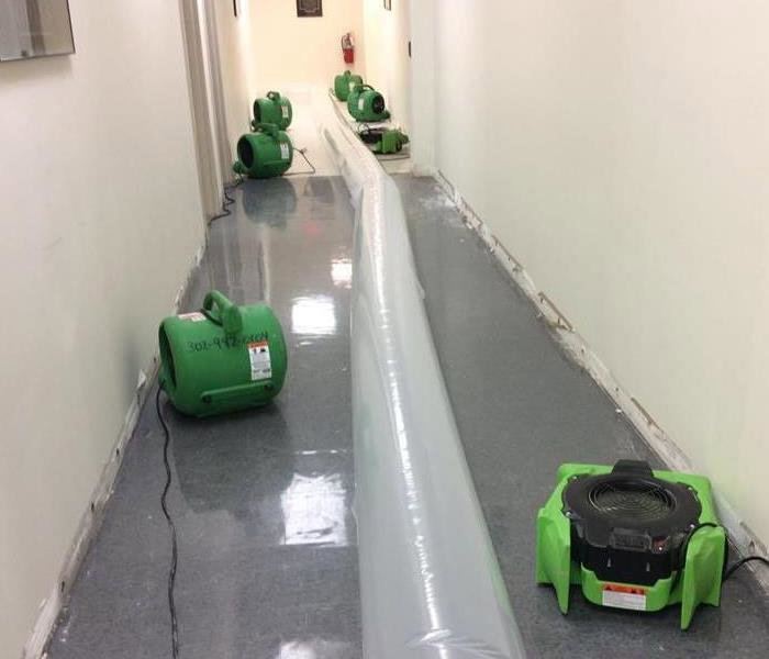 SERVPRO drying equipment and air movers set up in a hallway to dry water damage in Wilmington, DE