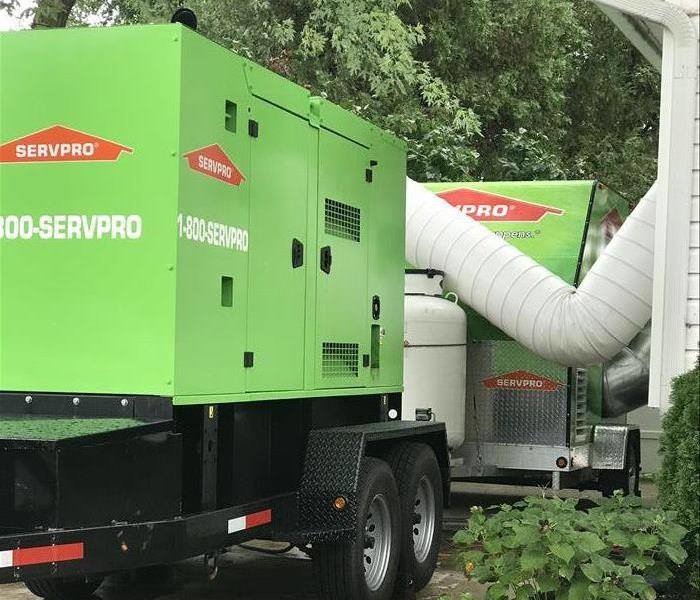 Large SERVPRO of Brandywine/Wilmington drying equipment with ducts set up outside a building for water damage restoration in Wilmington, DE.