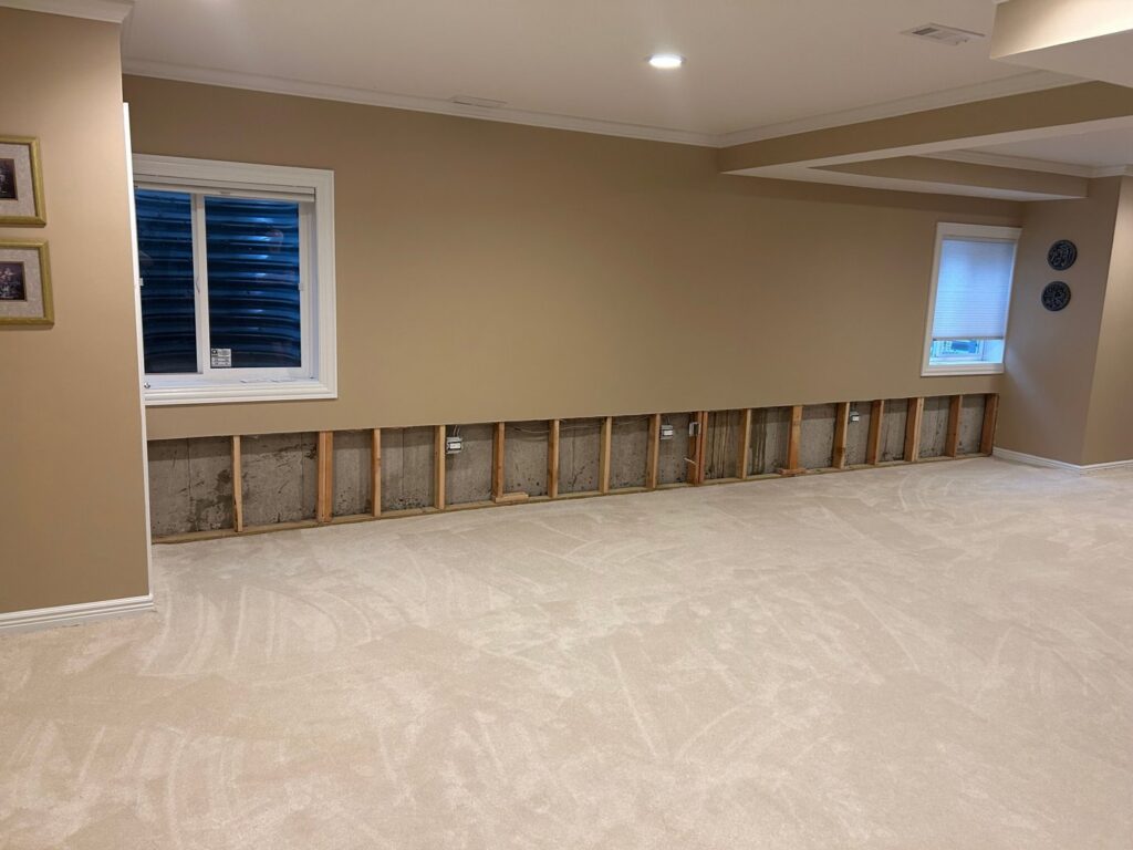 SERVPRO North Kenosha performing water damage remediation with removed drywall and exposed studs in Kenosha, WI.