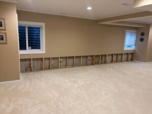 SERVPRO North Kenosha performing water damage remediation with removed drywall and exposed studs in Kenosha, WI.