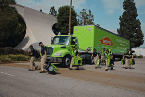 A Servpro disaster recovery team with equipment walking from their truck in Honolulu, HI.