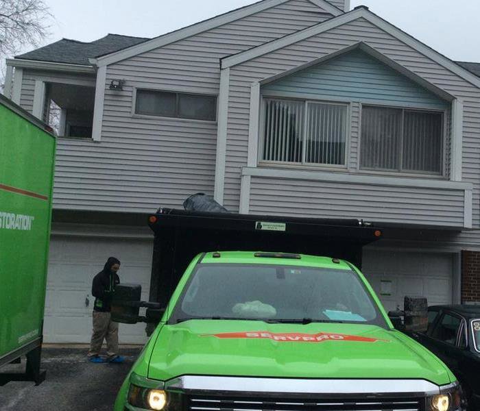 SERVPRO of Newark truck and dumpster on site for debris removal after water damage restoration in Wilmington, DE