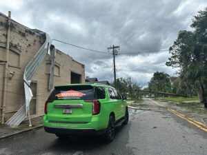 A SERVPRO vehicle parked on a street after storm damage, indicating restoration work in Boise/Meridian, ID