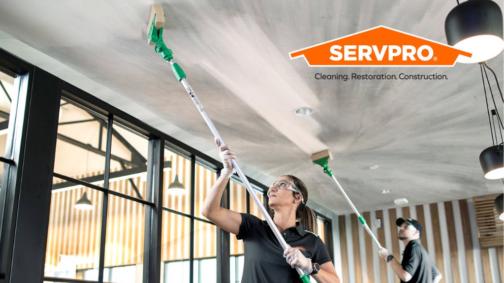 Servpro workers cleaning a ceiling with long-handled tools for Servpro of SW Onondaga County in Syracuse, NY.