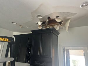Severe ceiling water damage in a kitchen, showing collapsed drywall, repaired by Guardian Angel Restoration in Noblesville, IN