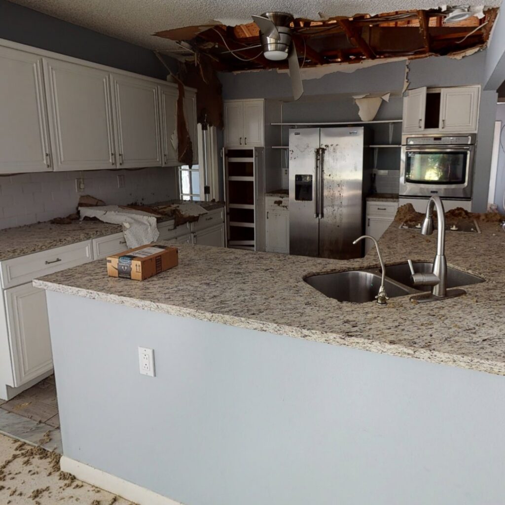 Kitchen showing severe water damage with a collapsed ceiling and debris, requiring restoration by Built Different Restoration in Gilbert, AZ.