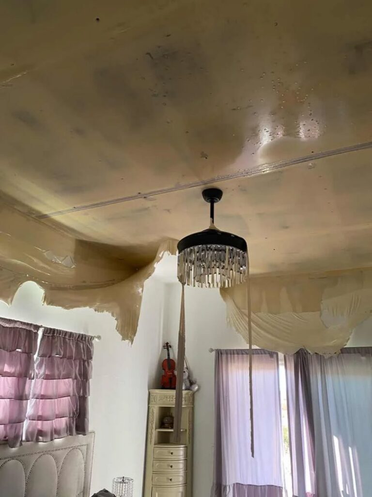 A ceiling with severe water damage and sagging drywall in a home in Gilbert, AZ, needing restoration by Western Skies Restoration.