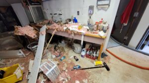 A severely damaged room with insulation and debris scattered, indicating extensive water damage requiring restoration by Utah Disaster Team in Layton, UT.