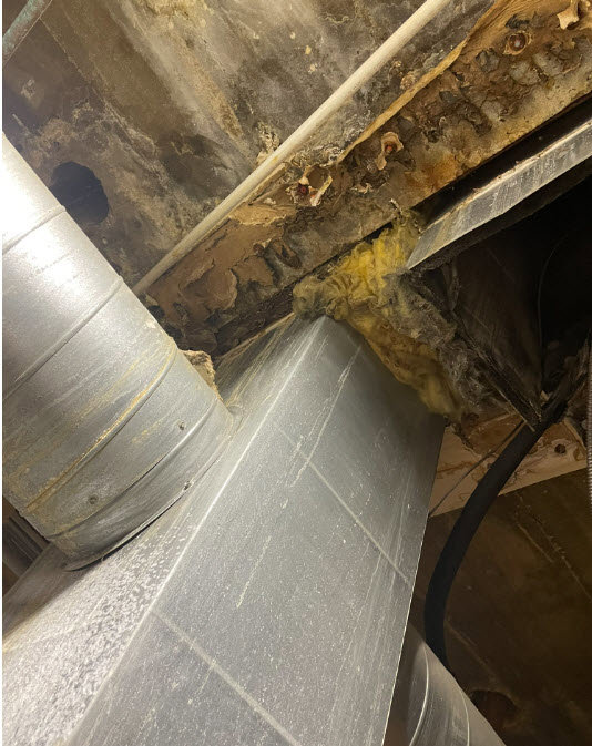 Severe water damage with rust and mold visible on a ceiling, indicating a need for restoration by RestoPros of Salt Lake City, UT