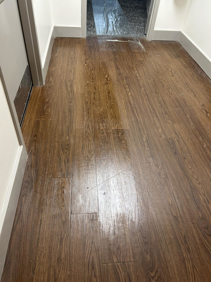 A shiny, freshly cleaned wood-look floor in a residential hallway by 360clean in North Charleston, SC