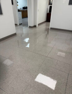 A shiny, clean tiled floor in a hallway, showcasing the results of professional cleaning by Statewide cleaning services llc in Philadelphia, PA.