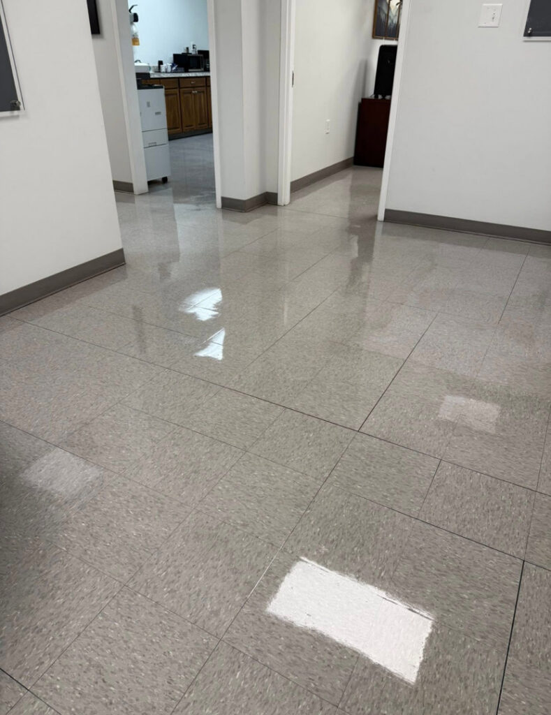A shiny, clean tiled floor in a hallway, showcasing the results of professional cleaning by Statewide cleaning services llc in Philadelphia, PA.