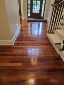 A shiny hardwood floor in a hallway after professional cleaning by Wonderful Laura Cleaning in Aurora, IL.