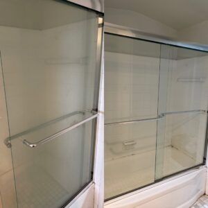 Before and after of a shower enclosure with sliding glass doors, now spotless thanks to GentleNest Home Cleaning in Livonia, MI.