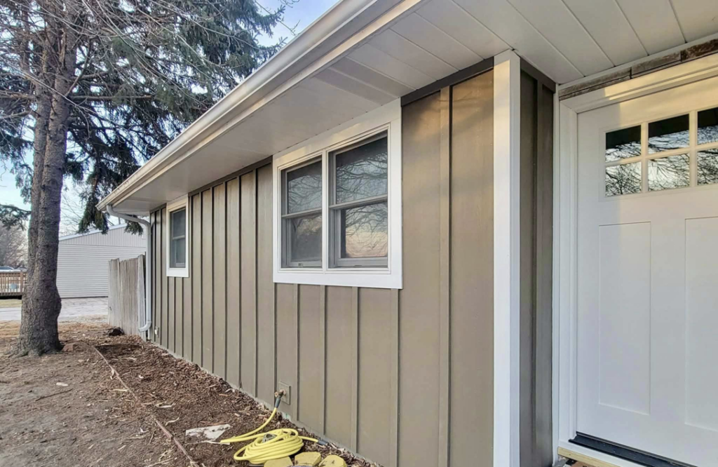 Side view of a house with newly installed vertical siding by D.A. Siding & Windows in Grand Island, NE.