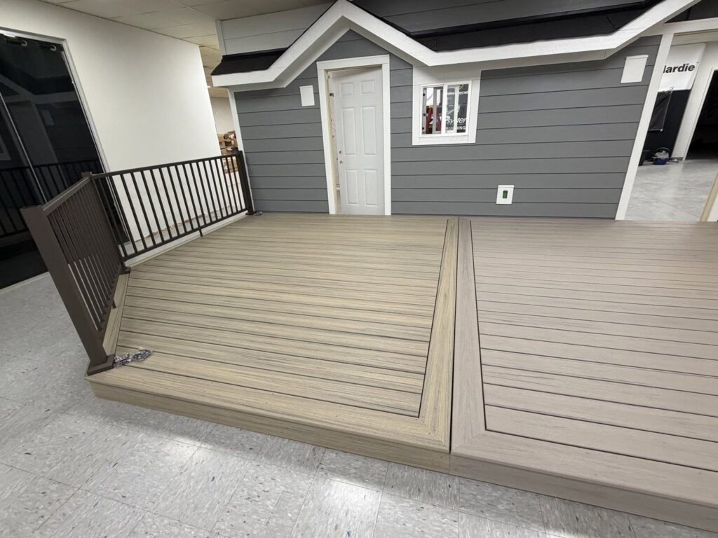 An indoor display showcasing gray siding and composite decking options by Stephenson Exteriors LLC in Cincinnati, OH.